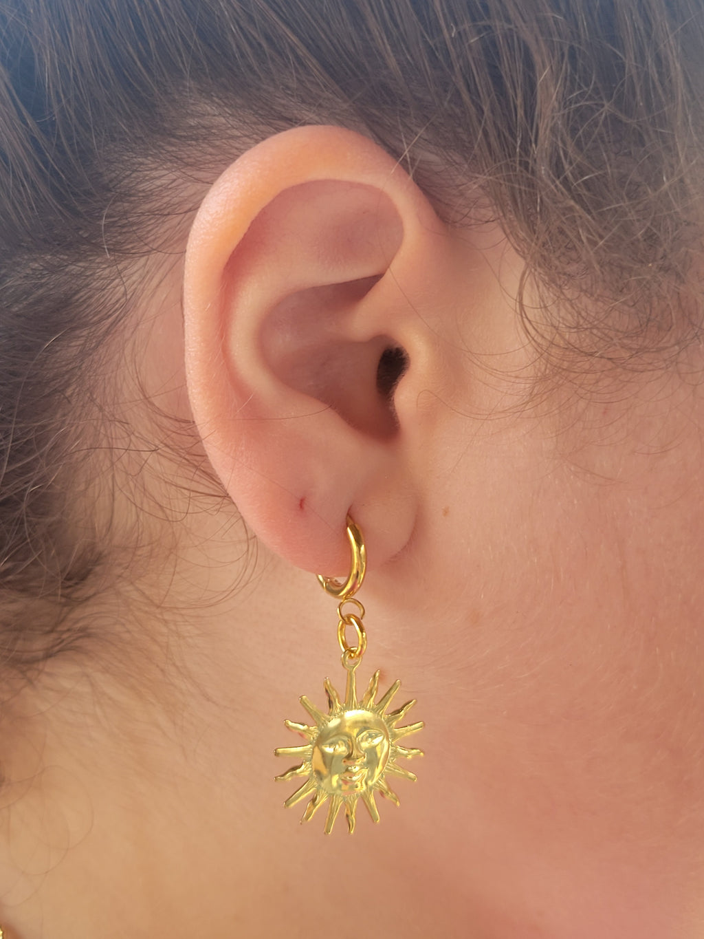 Woman wearing gold earrings from Sherami Collection