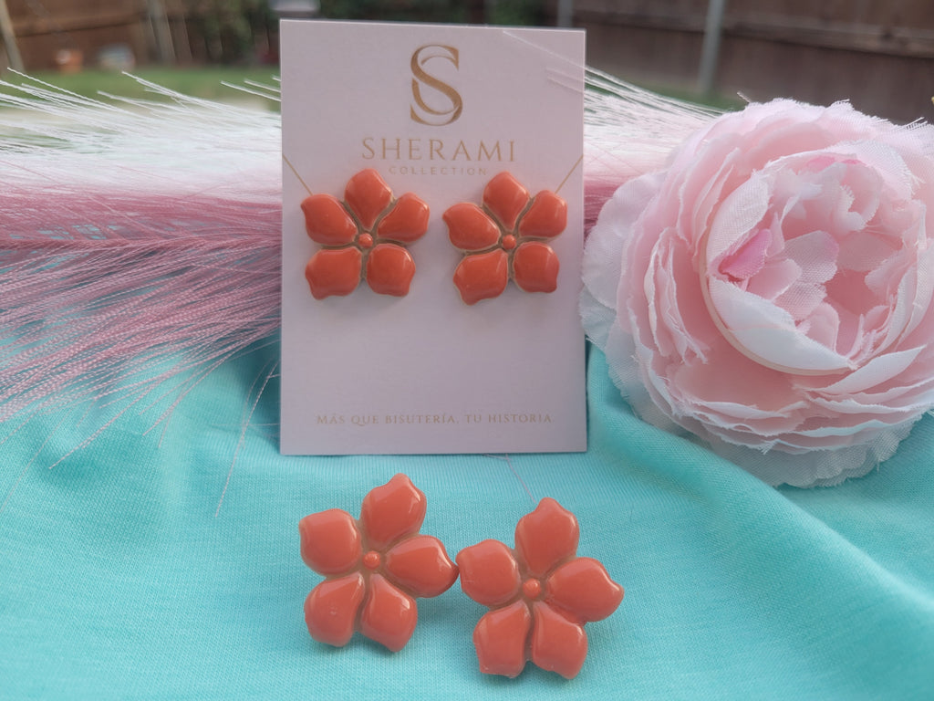 Floral earrings on a Sherami Collection branded card with a pink flower in the background.
