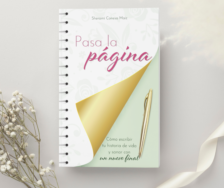 Libro titulado 'Pasa la página' con un bolígrafo  en la portada y flores sobre un fondo claro.